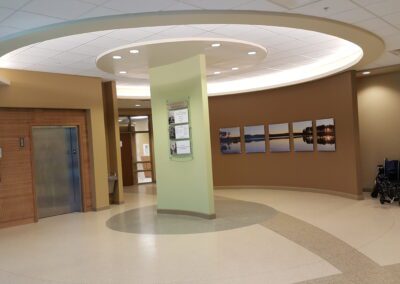 The lobby of a hospital with a circular staircase.