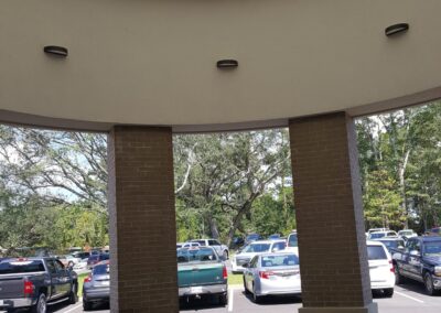 A view of a parking lot with cars parked under a glass dome.