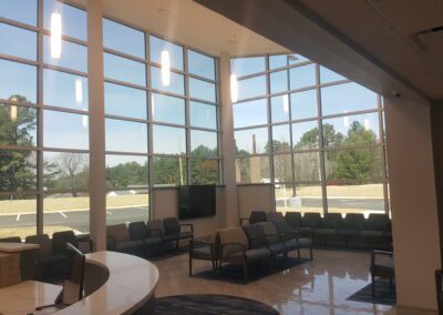 The reception area of a medical office with large windows.