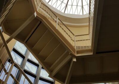A circular skylight in a building with stairs.